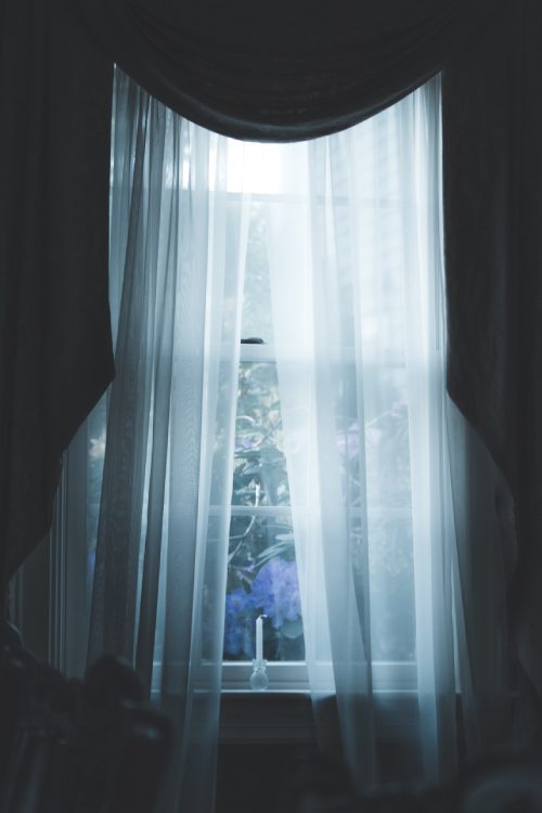 sheer curtains and blue drapes