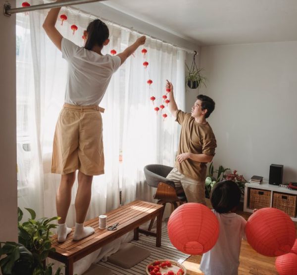 man and woman decorating by showing how and Where to place Curtain Rods: