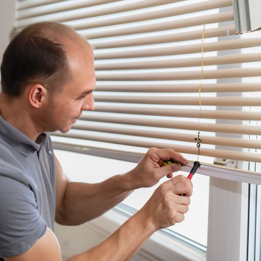 a man is showing how to fix cordless blinds with a broken string