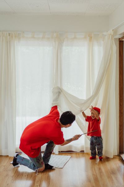 the man and child are cleaning custom-made curtains