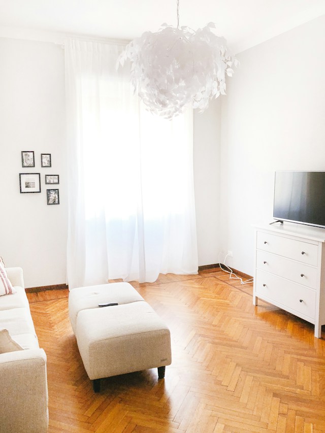 White sheer curtains in a bedroom illustrating the benefits of custom-made drapes