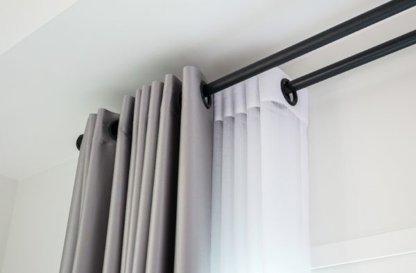 Black and white curtains with a black rod using black curtain rings without clips.
