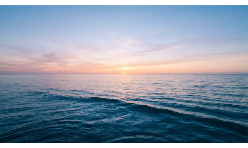 3 Screen Wallpaper With a Calm Ocean Horizon